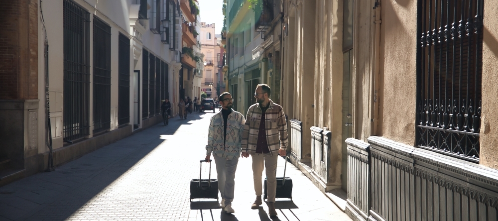 A couple walking down the street with suitcases