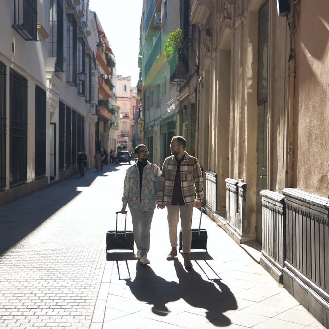 A couple walking down the street with suitcases