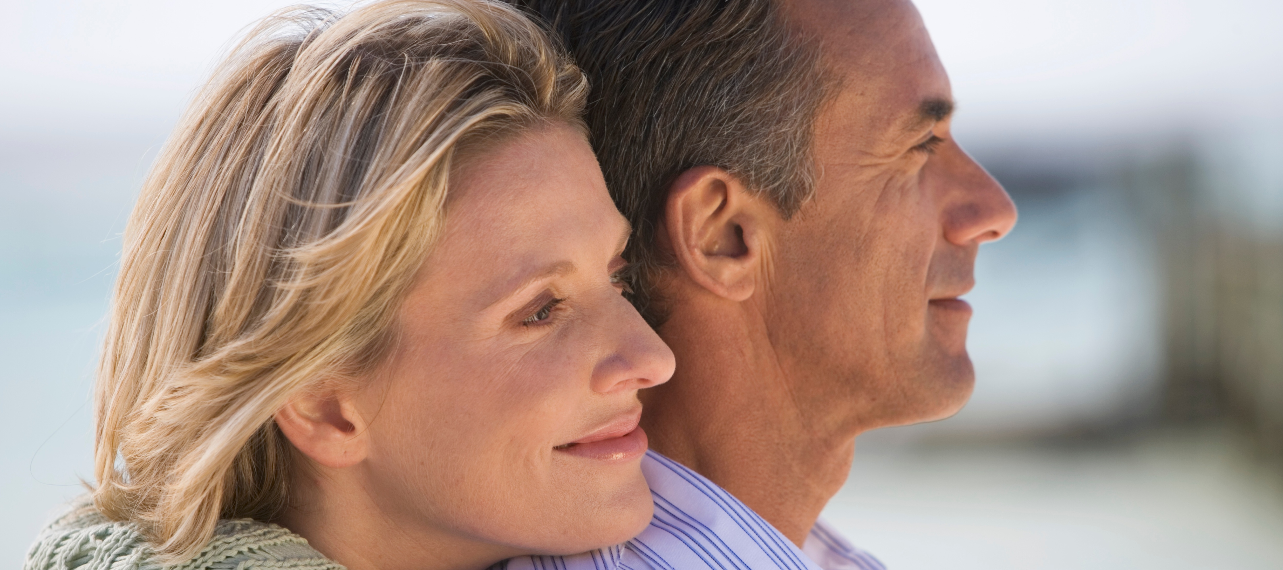 60-year-old couple looking standing outside