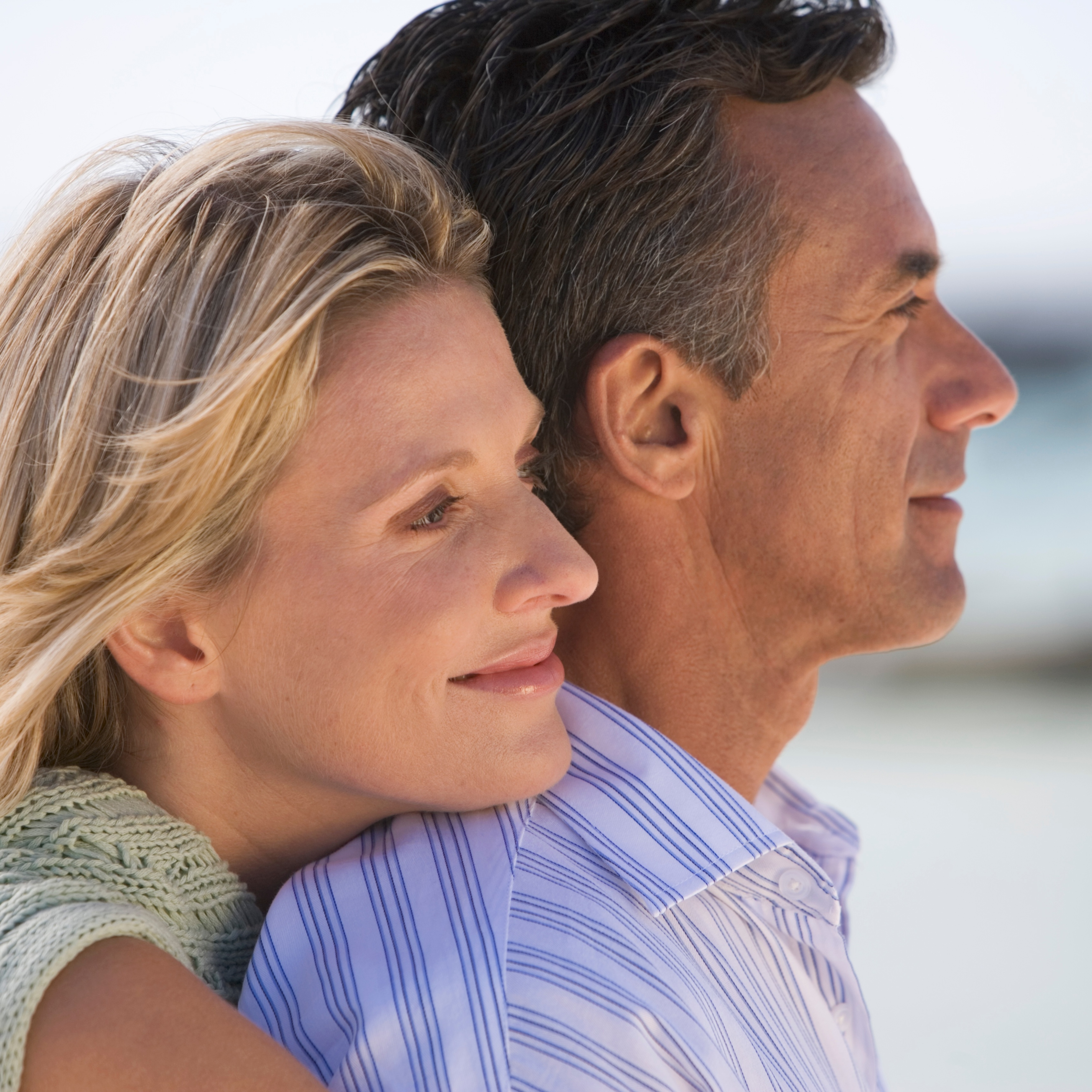 60-year-old couple looking standing outside