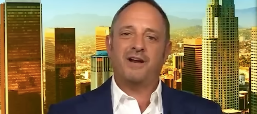 Andrew Left speaks during a news broadcast.