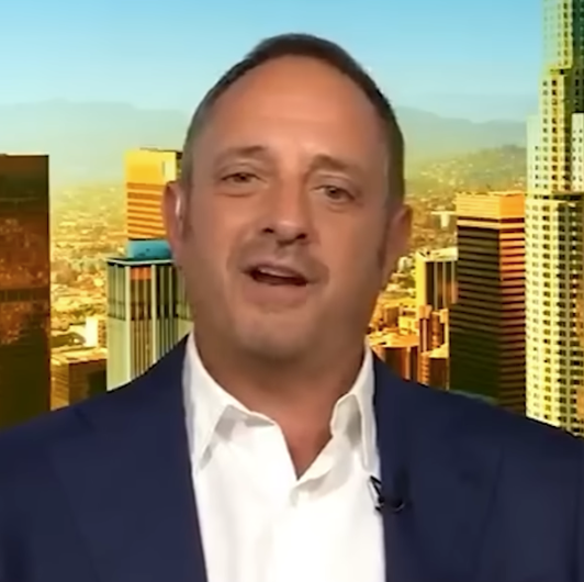 Andrew Left speaks during a news broadcast.