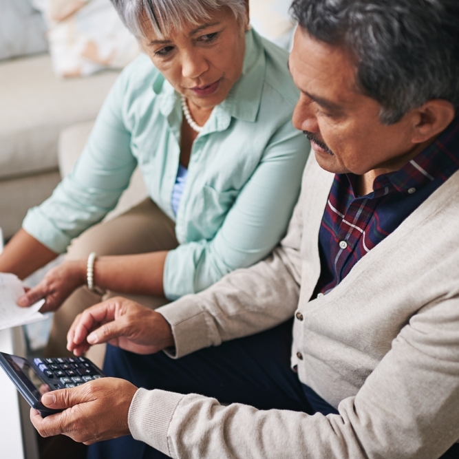 A photo of a middle-aged couple reviewing their finances together
