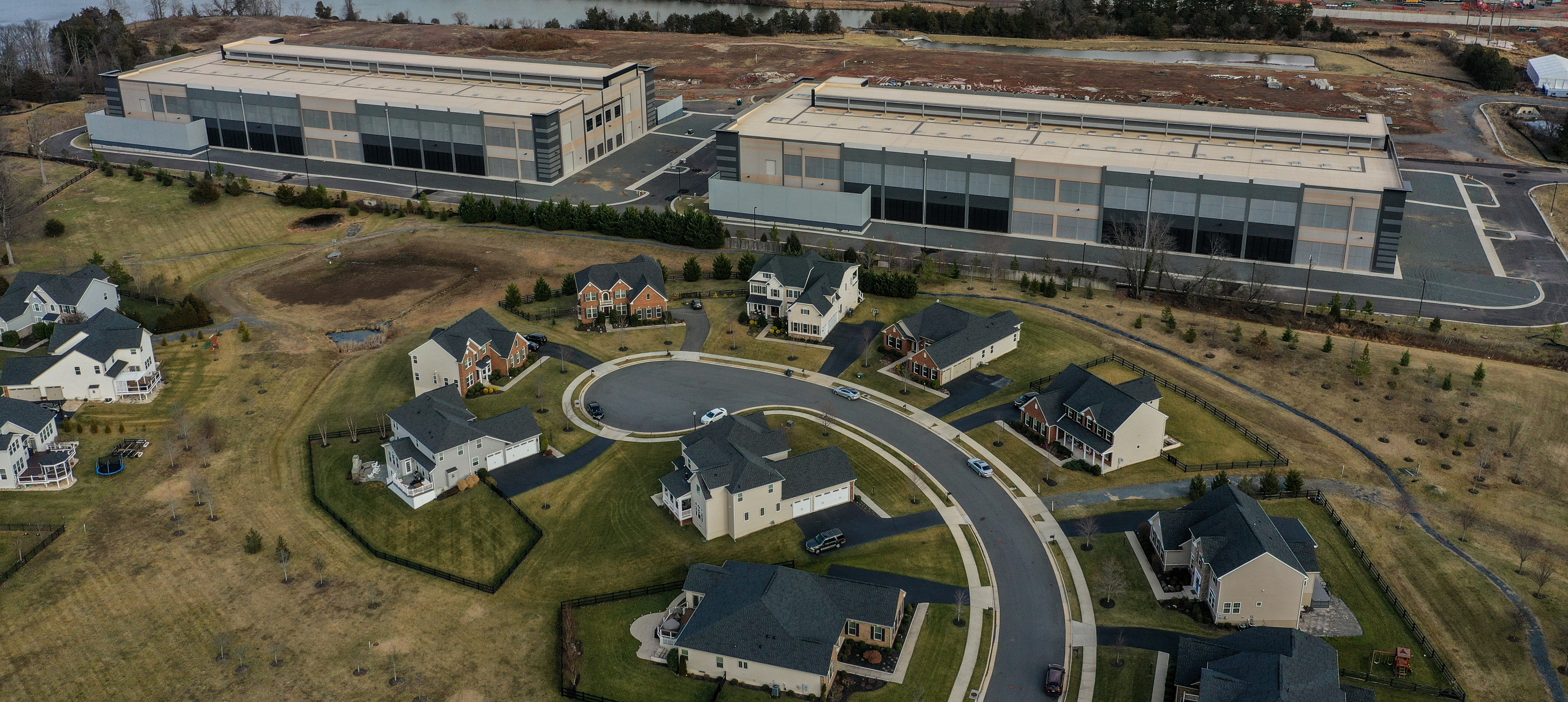 Amazon data centers have been built as close as 50 feet from residential houses in the Loudoun Meadows neighborhood in Aldie, Virginia.