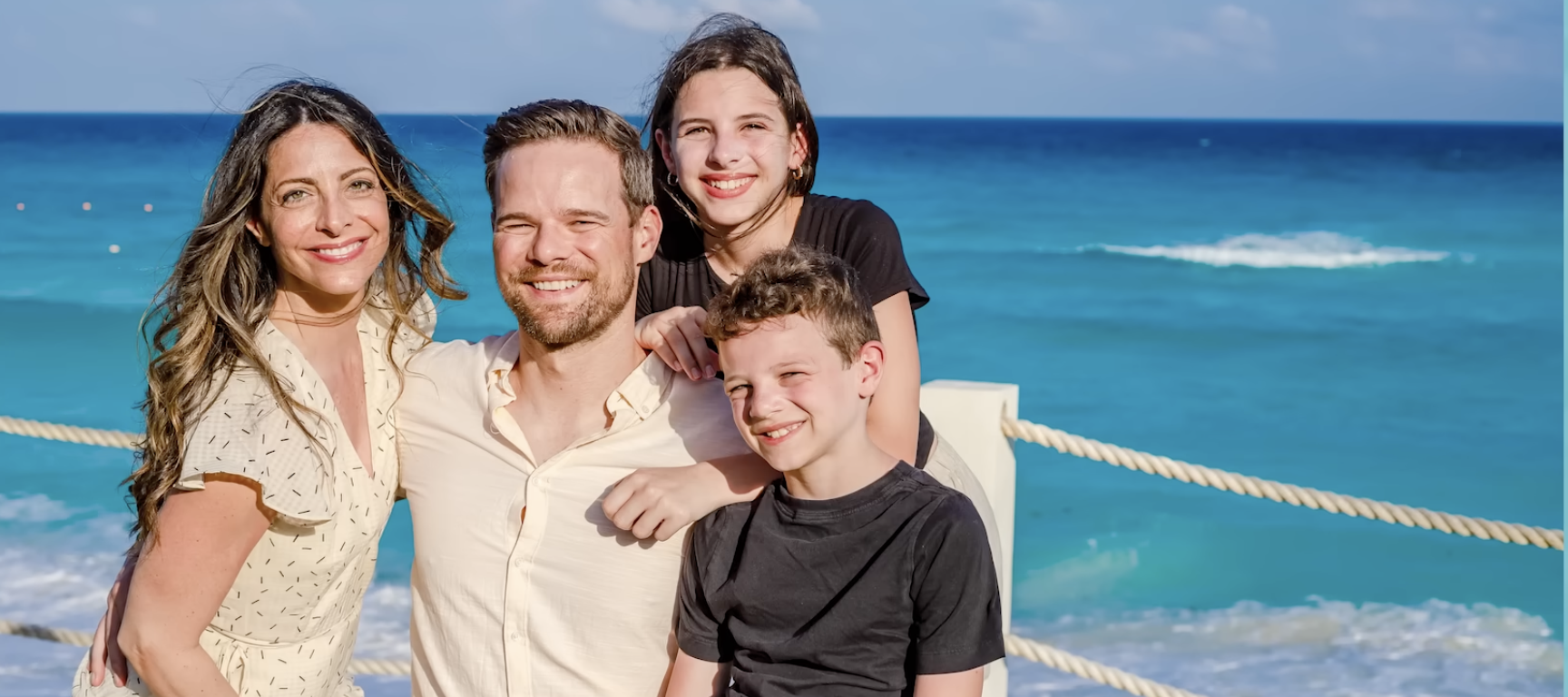 Andy Hill, his wife and two children by the seaside. They've reached their financial goals and plan to scale back on saving for retirement.