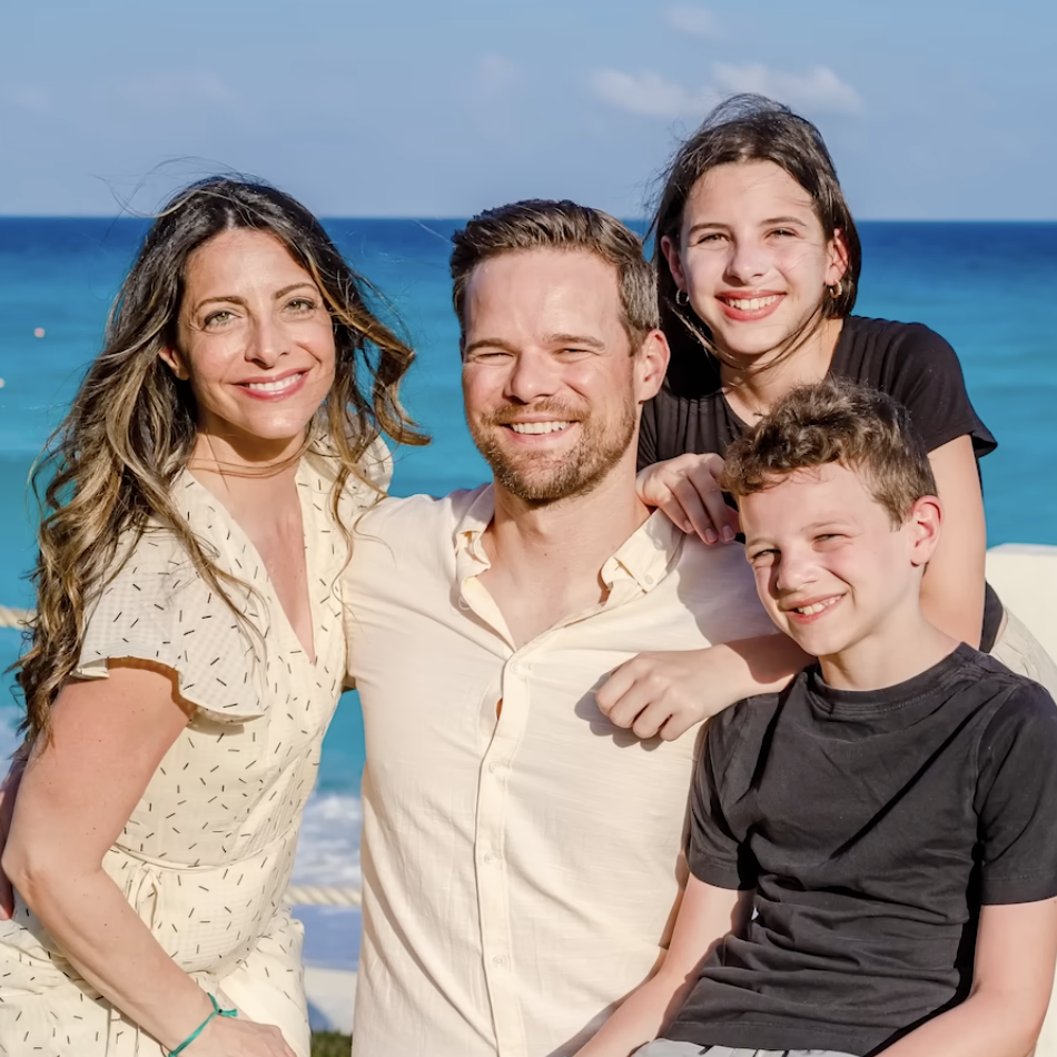 Andy Hill, his wife and two children by the seaside. They've reached their financial goals and plan to scale back on saving for retirement.