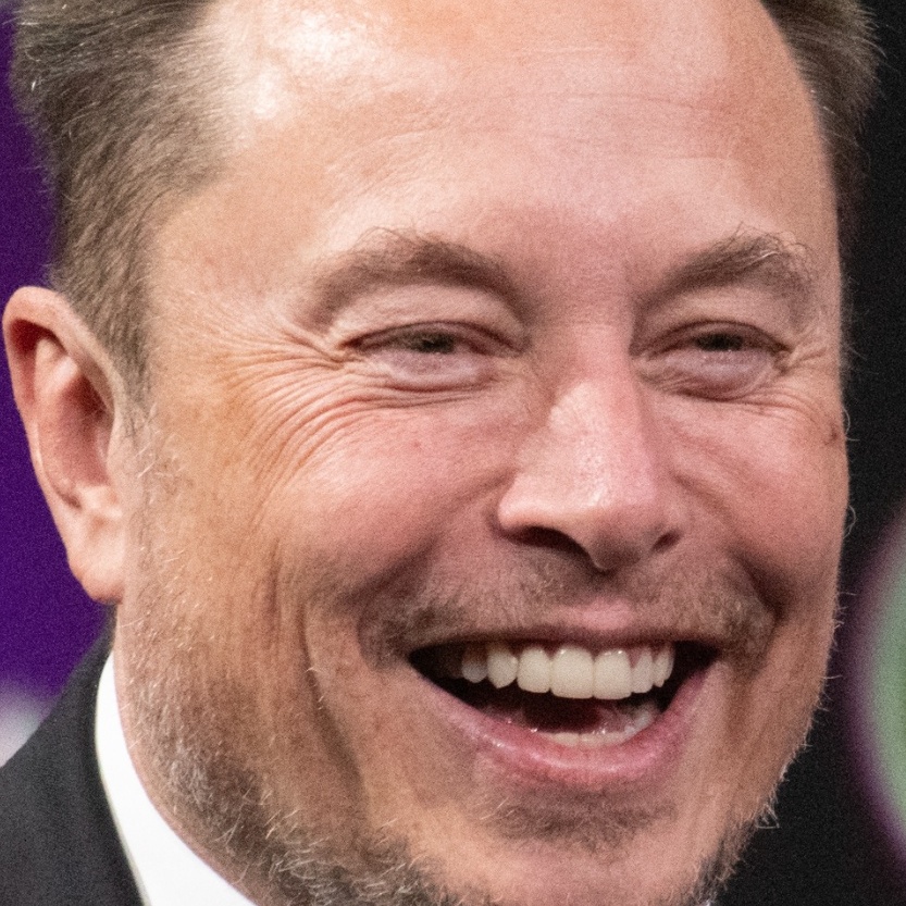 Elon Musk laughing on stage