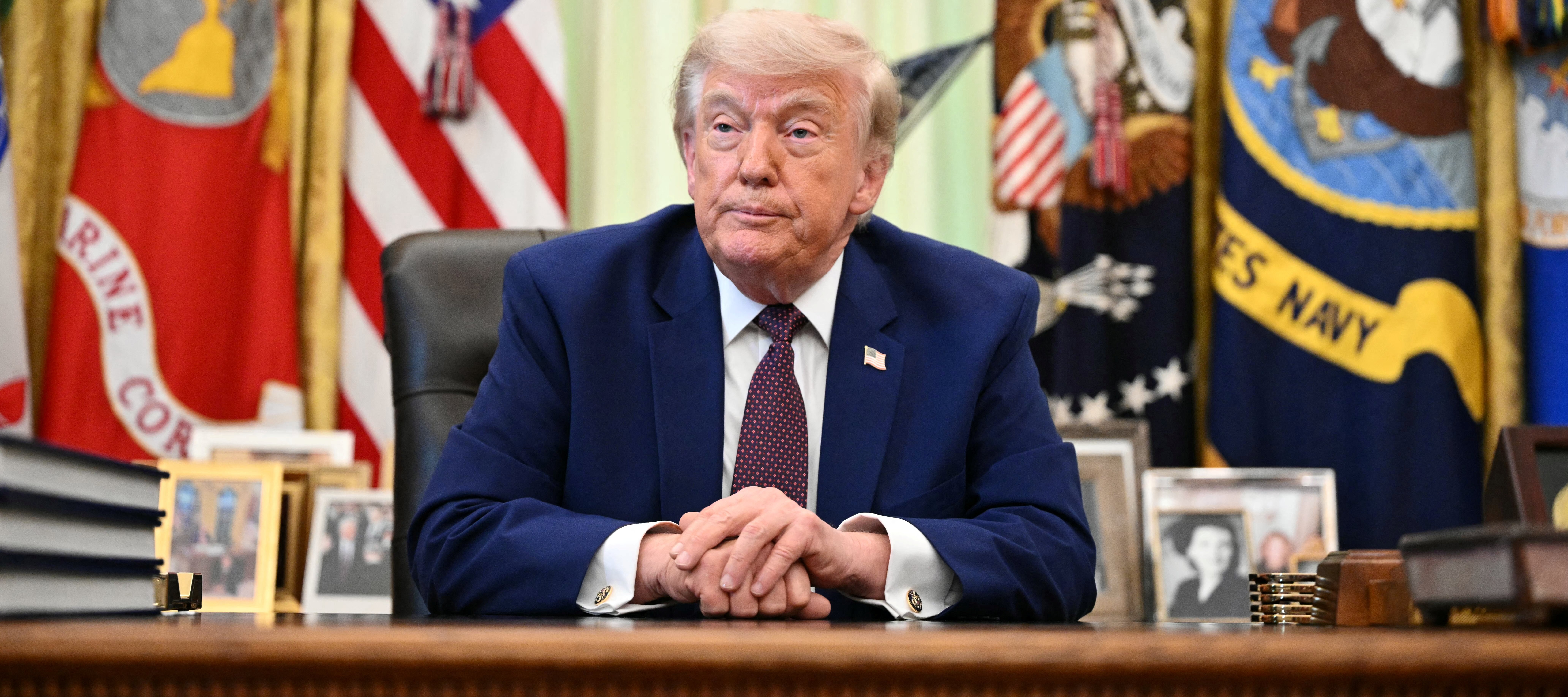 President Trump speaks to the press in the Oval Office of the White House.