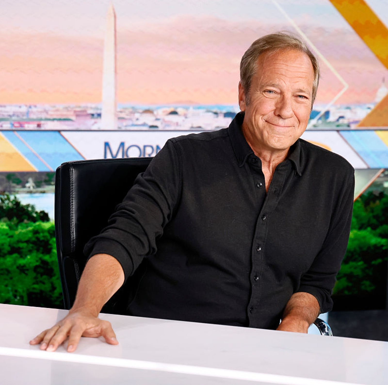Photo of Mike Rowe, host of "Dirty Jobs," and construction workers.