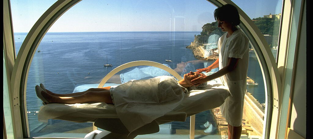 A photo of a person laying on a table at a doctor's office with views of the ocean