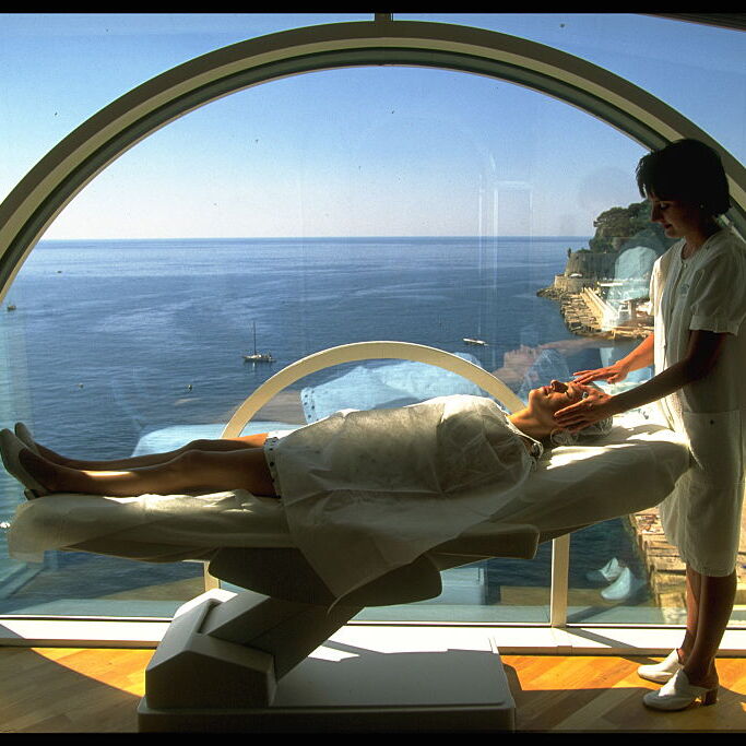 A photo of a person laying on a table at a doctor's office with views of the ocean