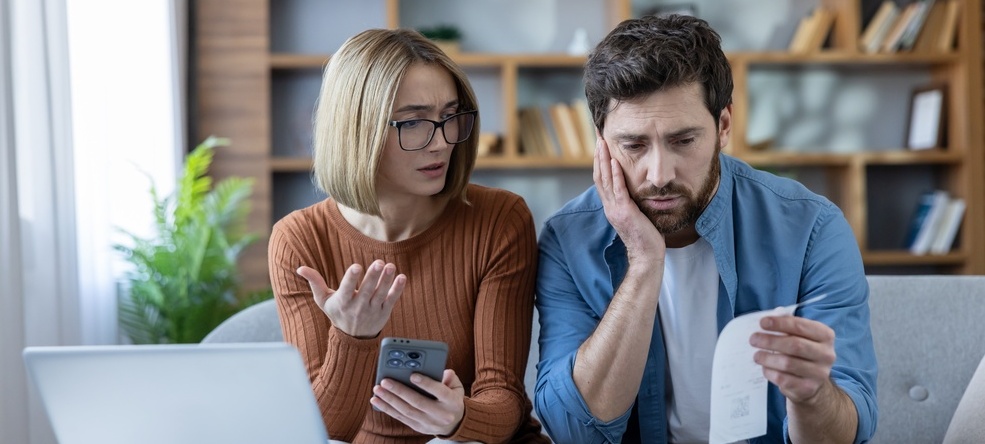 Photo of a couple looking dismayed