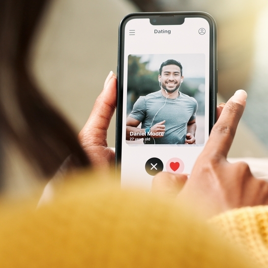 A photo of a woman swiping on a dating app