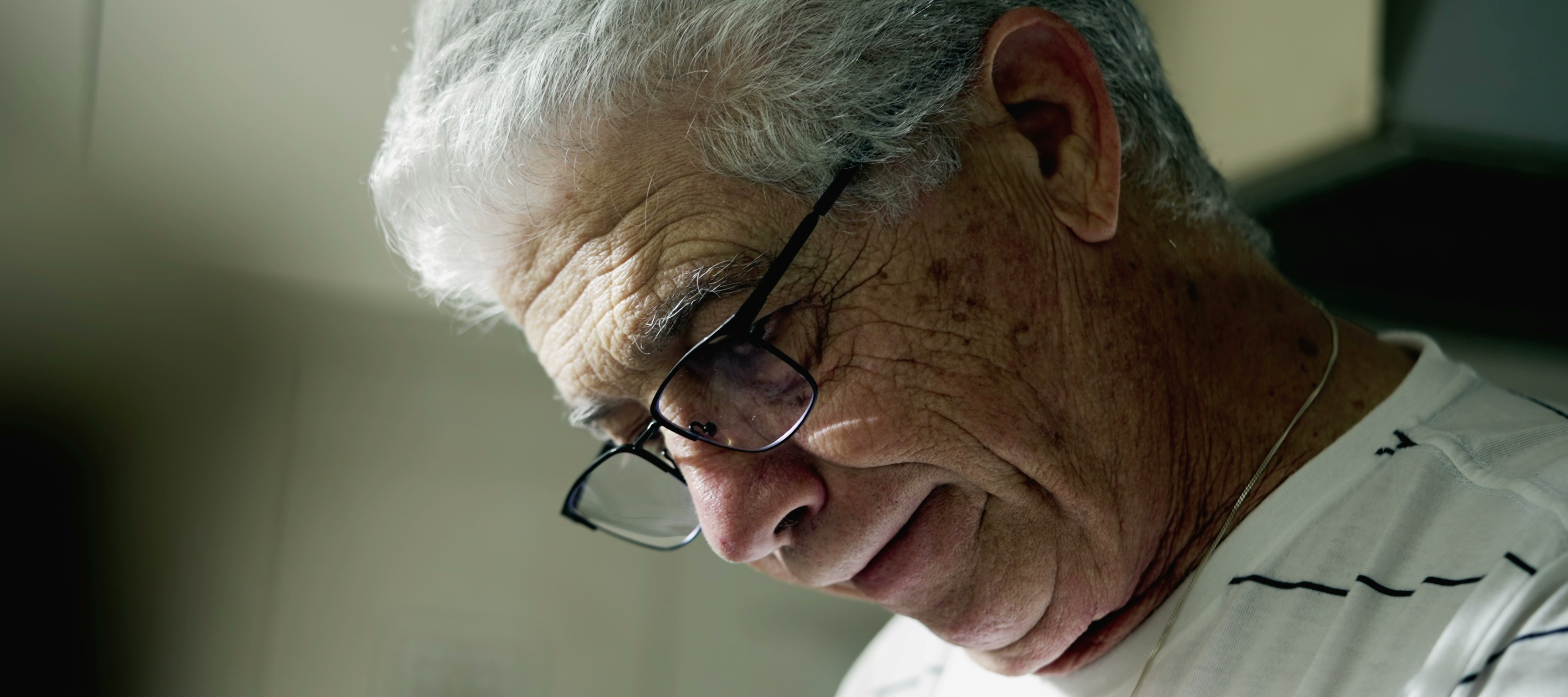 An old man looking down, sad