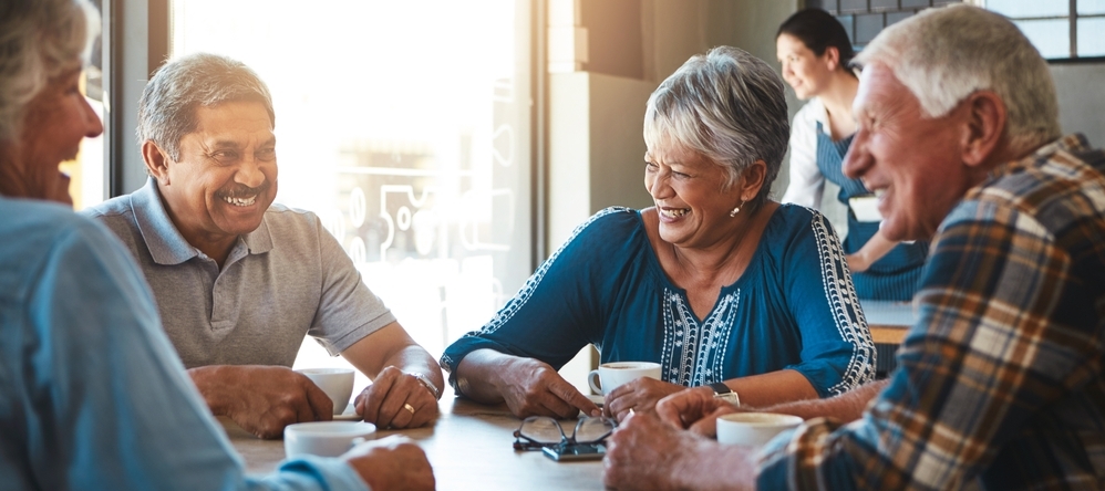 Elderly friends group relax at coffee shop on holiday or together on vacation in retirement.