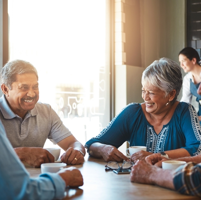 Elderly friends group relax at coffee shop on holiday or together on vacation in retirement.