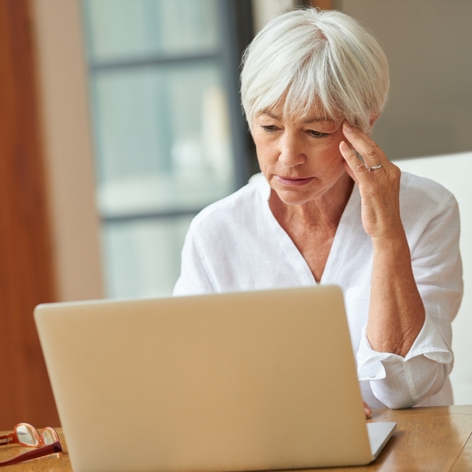 A photo of an older woman thinking