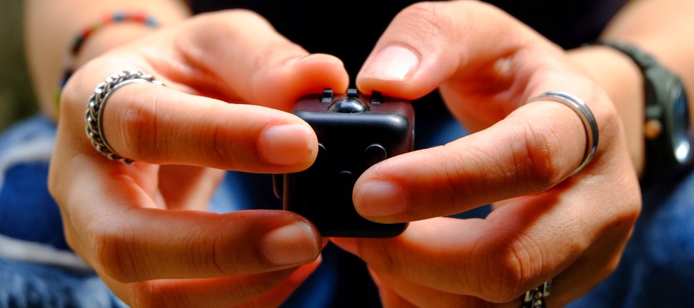 A photo of someone playing with a fidget clicker