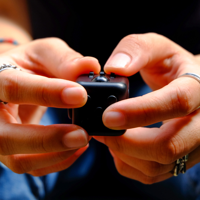 A photo of someone playing with a fidget clicker