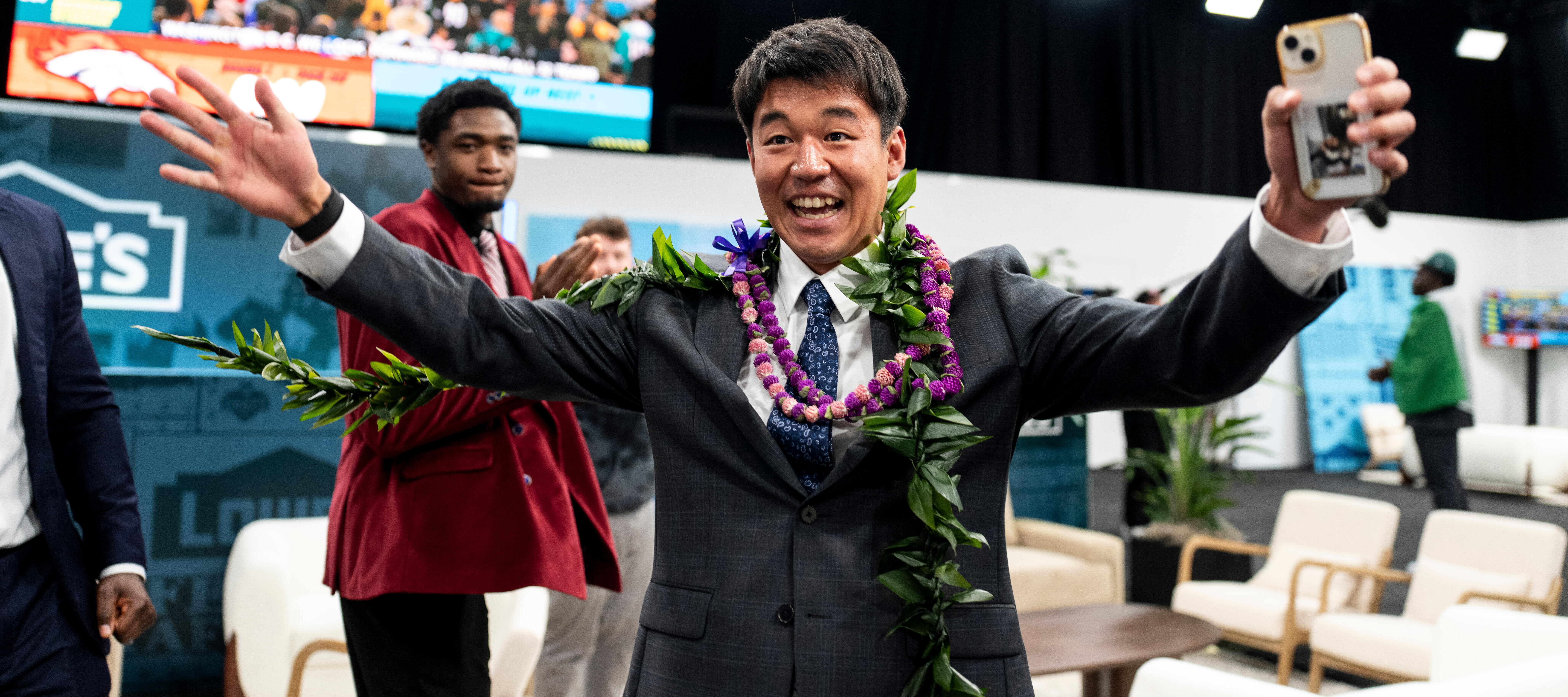 Kansei Matsuzawa reacts as he signs with the Las Vegas Raiders.