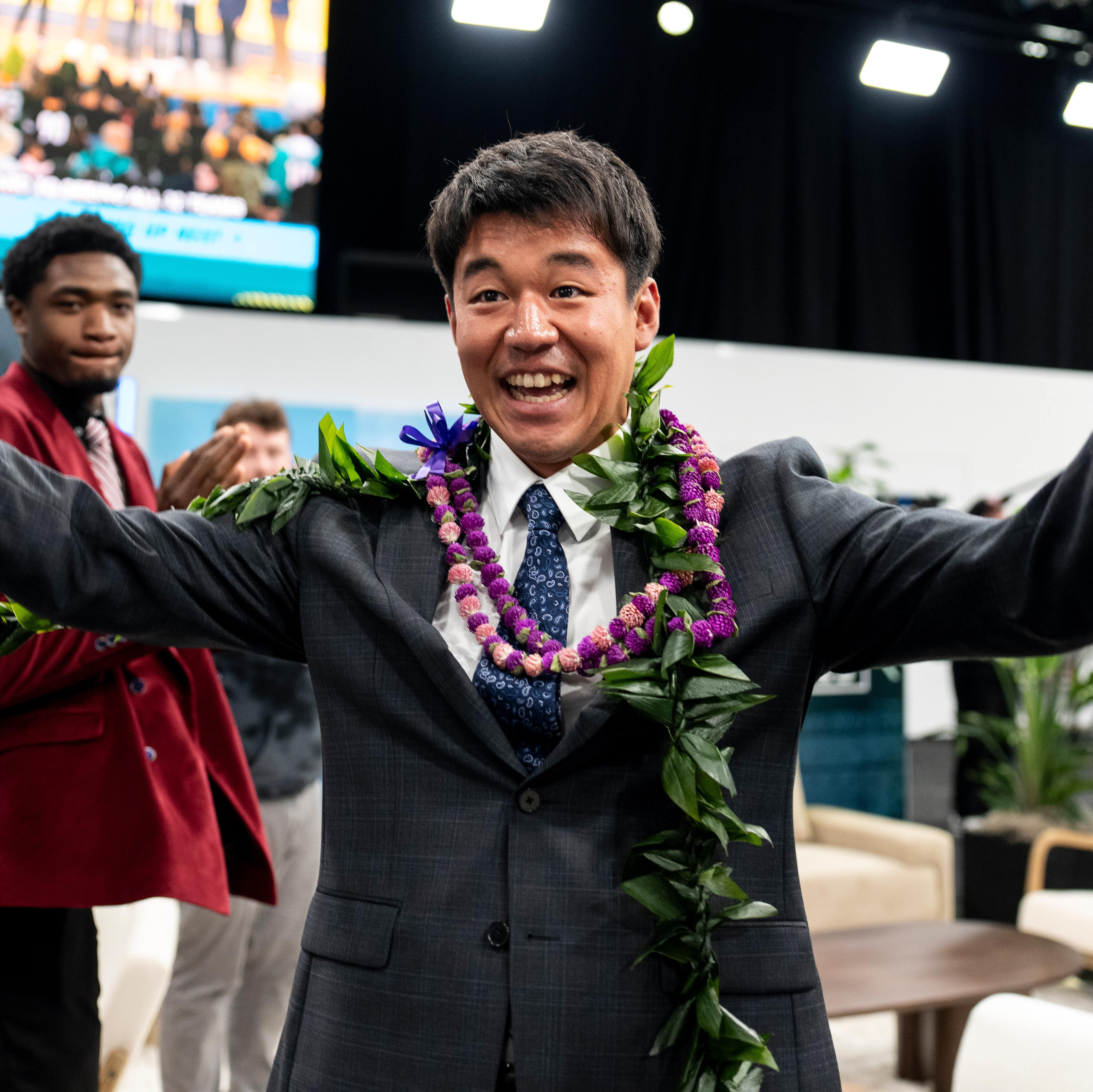 Kansei Matsuzawa reacts as he signs with the Las Vegas Raiders.
