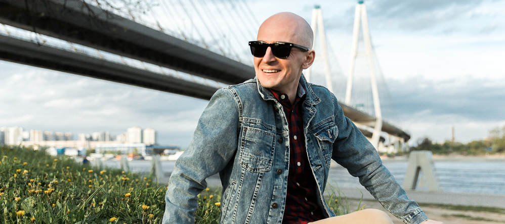 Man sitting near bridge.