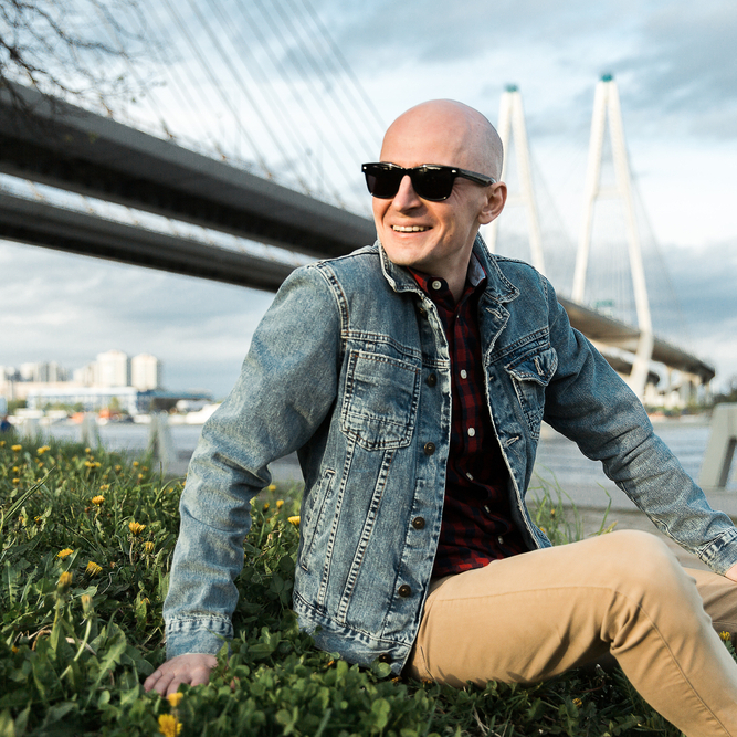 Man sitting near bridge.