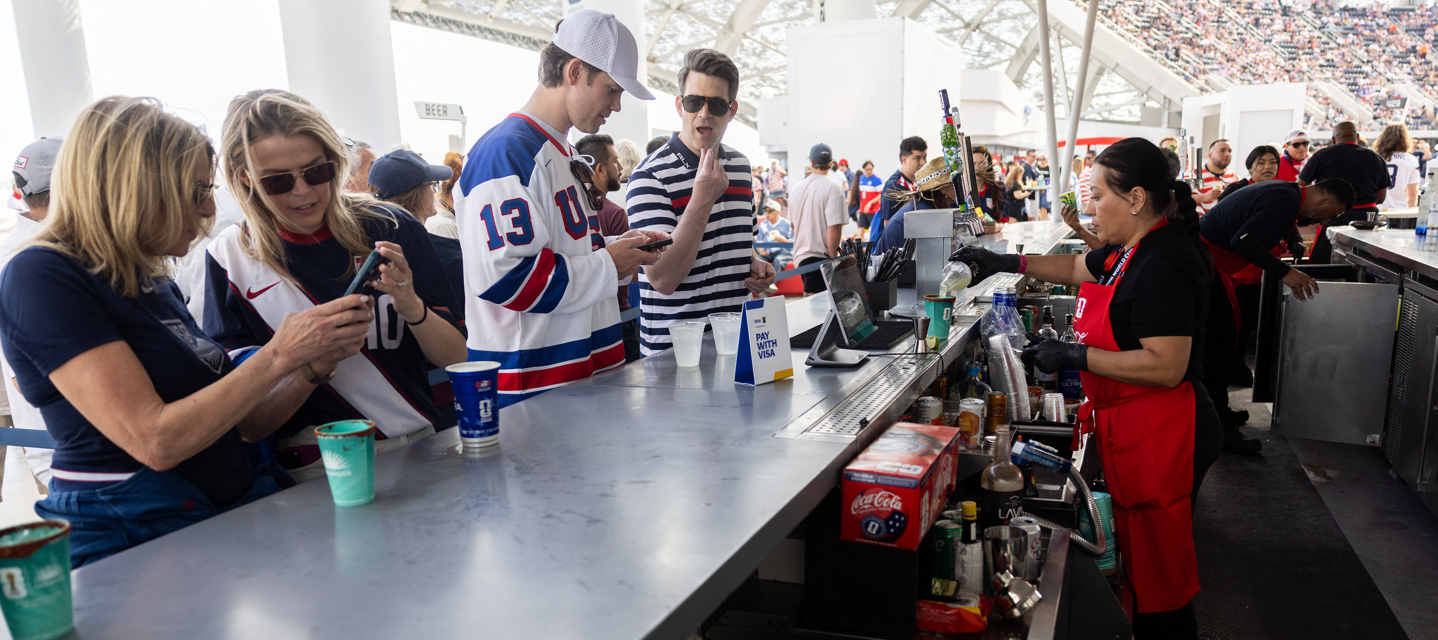 Fans buy snacks and beverages at a concession stand during the 2026 World Cup Group D football match between USA and Paraguay at the Los Angeles Stadium in Inglewood.