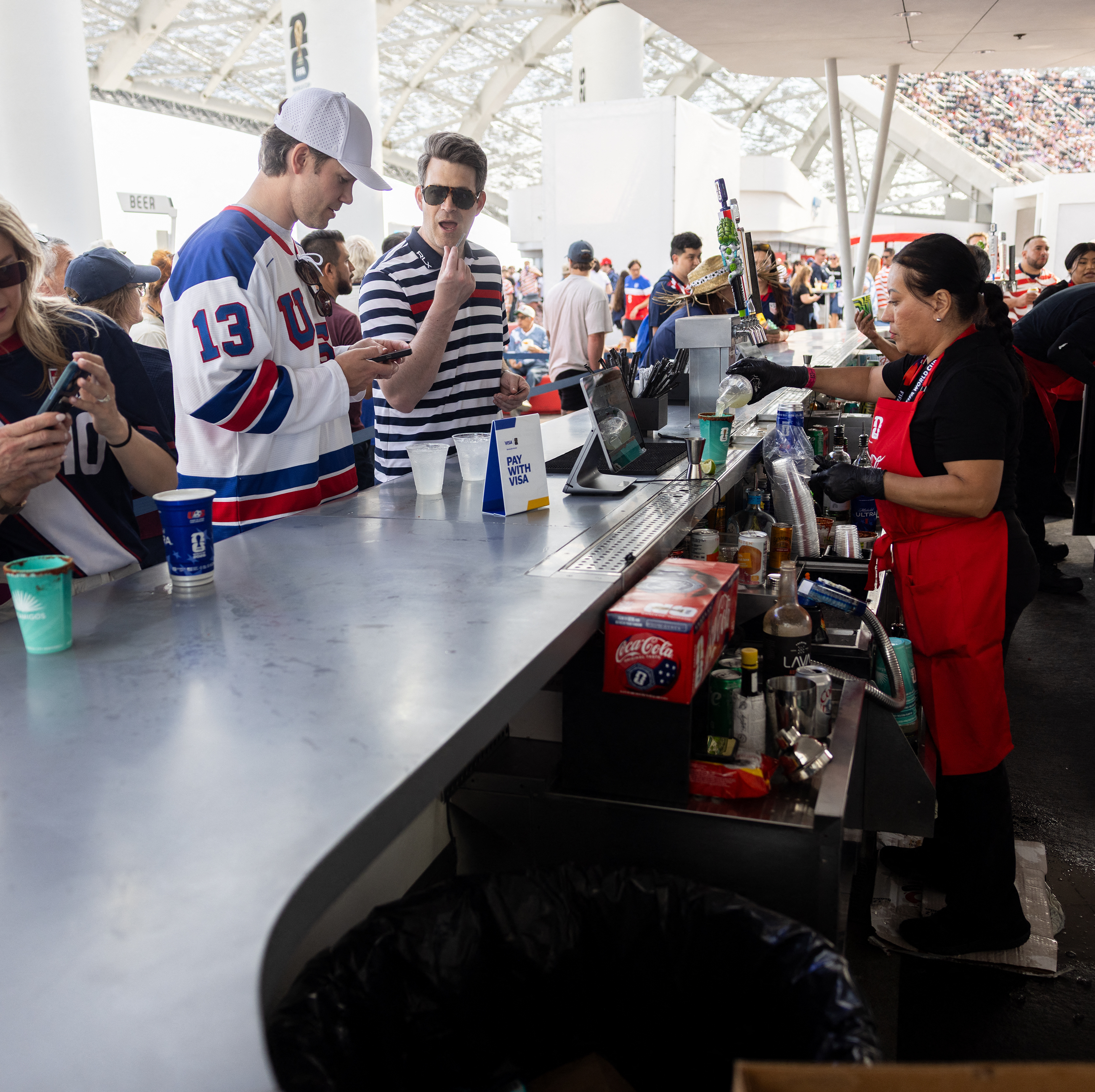 Fans buy snacks and beverages at a concession stand during the 2026 World Cup Group D football match between USA and Paraguay at the Los Angeles Stadium in Inglewood.