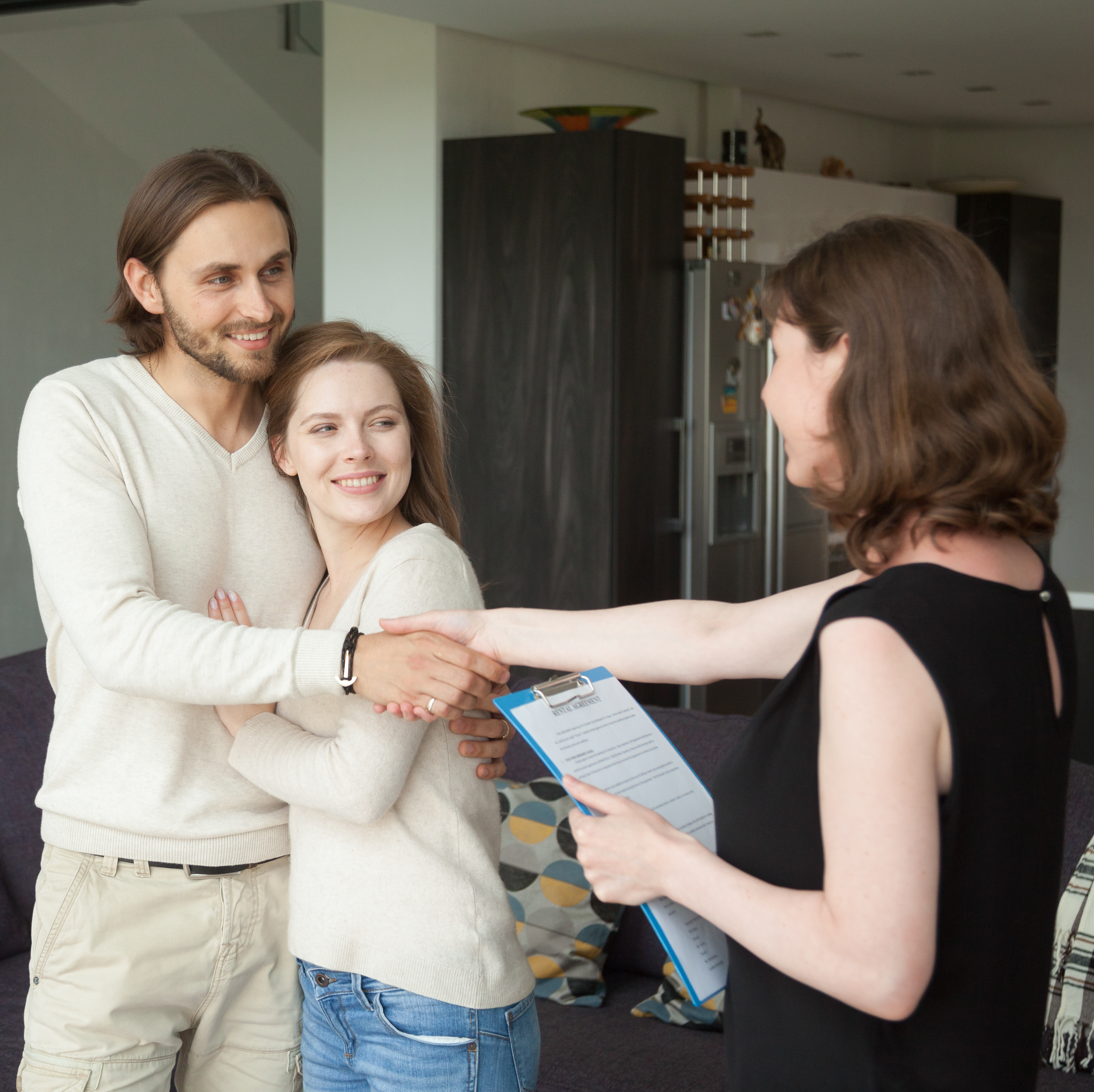 A landlord showing a home to a young couple.