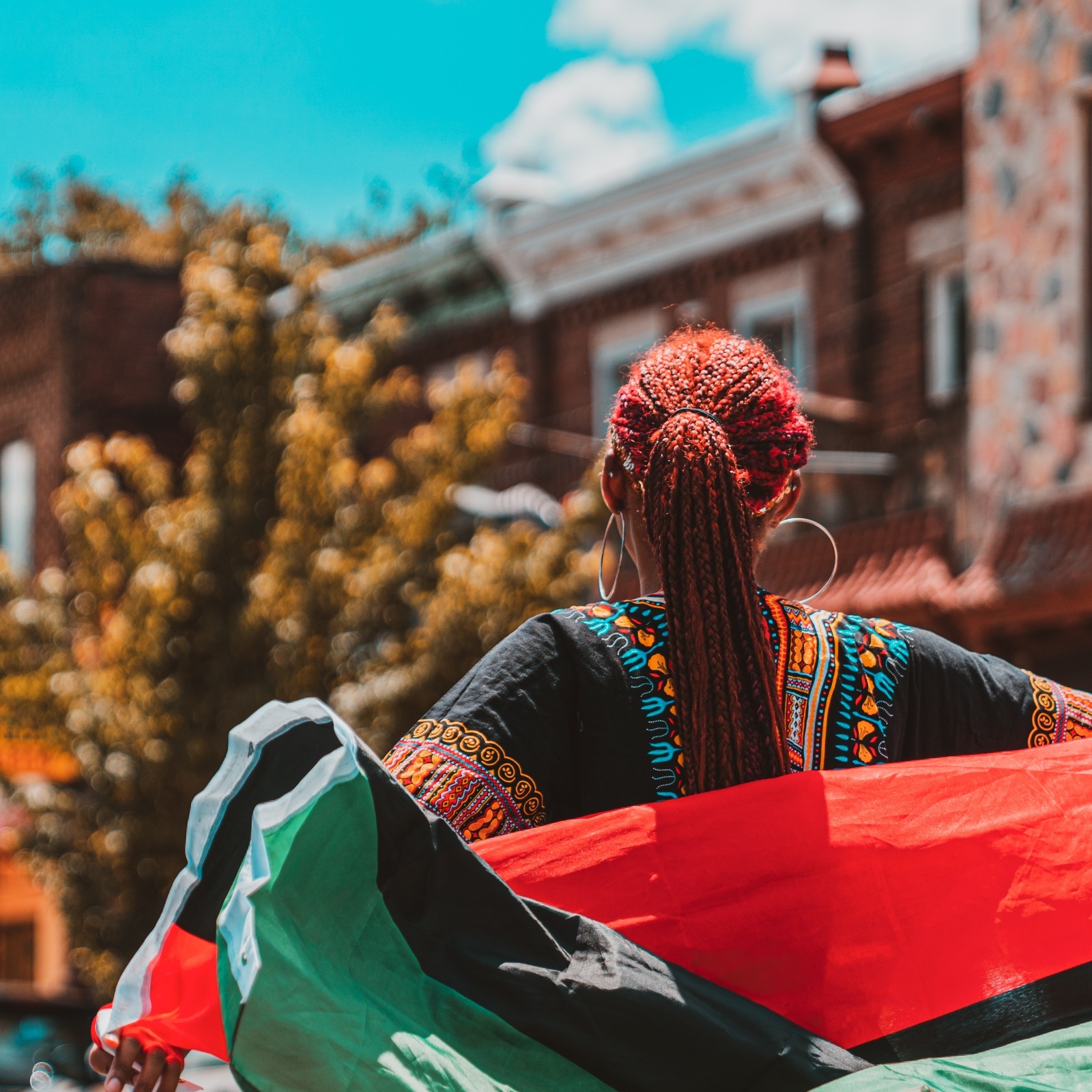 A Black woman wearing an African flag during a Juneteenth parade in Philadelphia