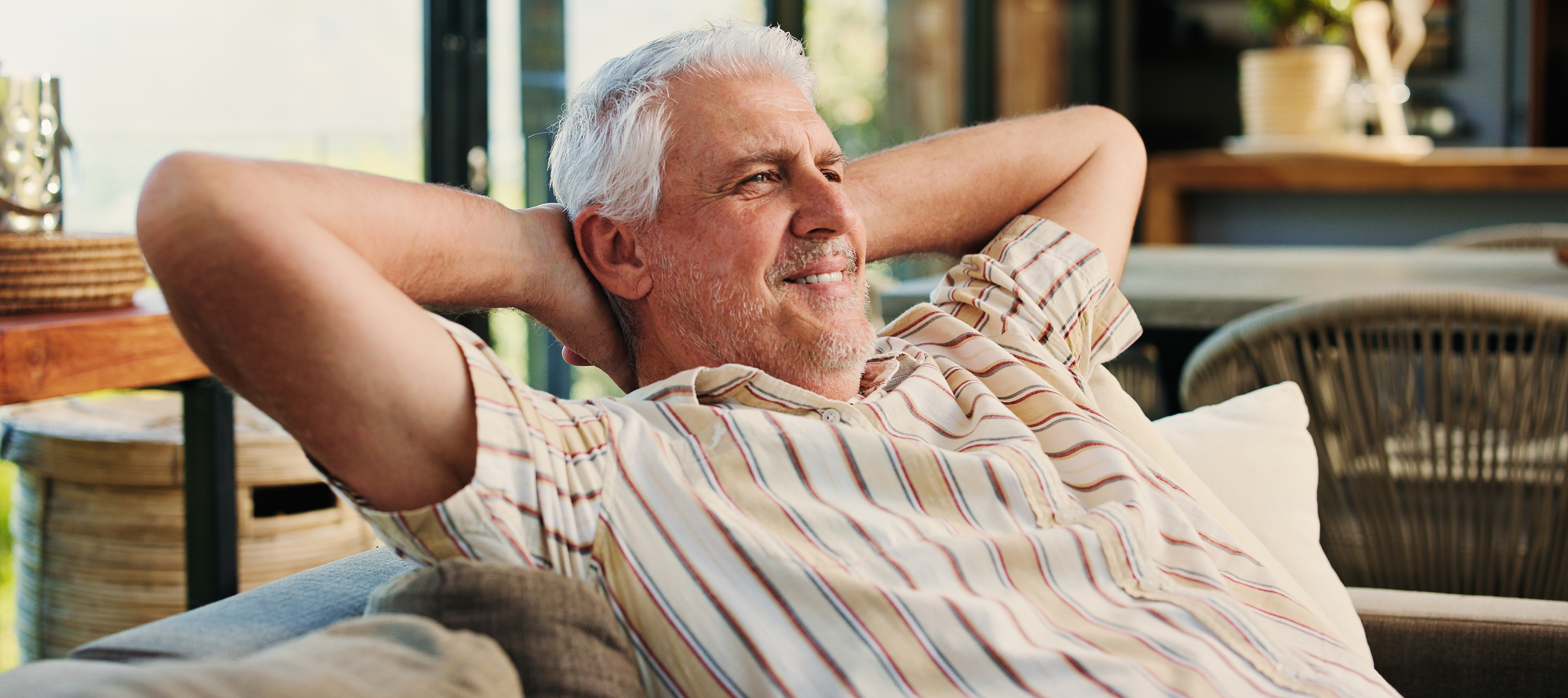 An older man relaxing on the couch.