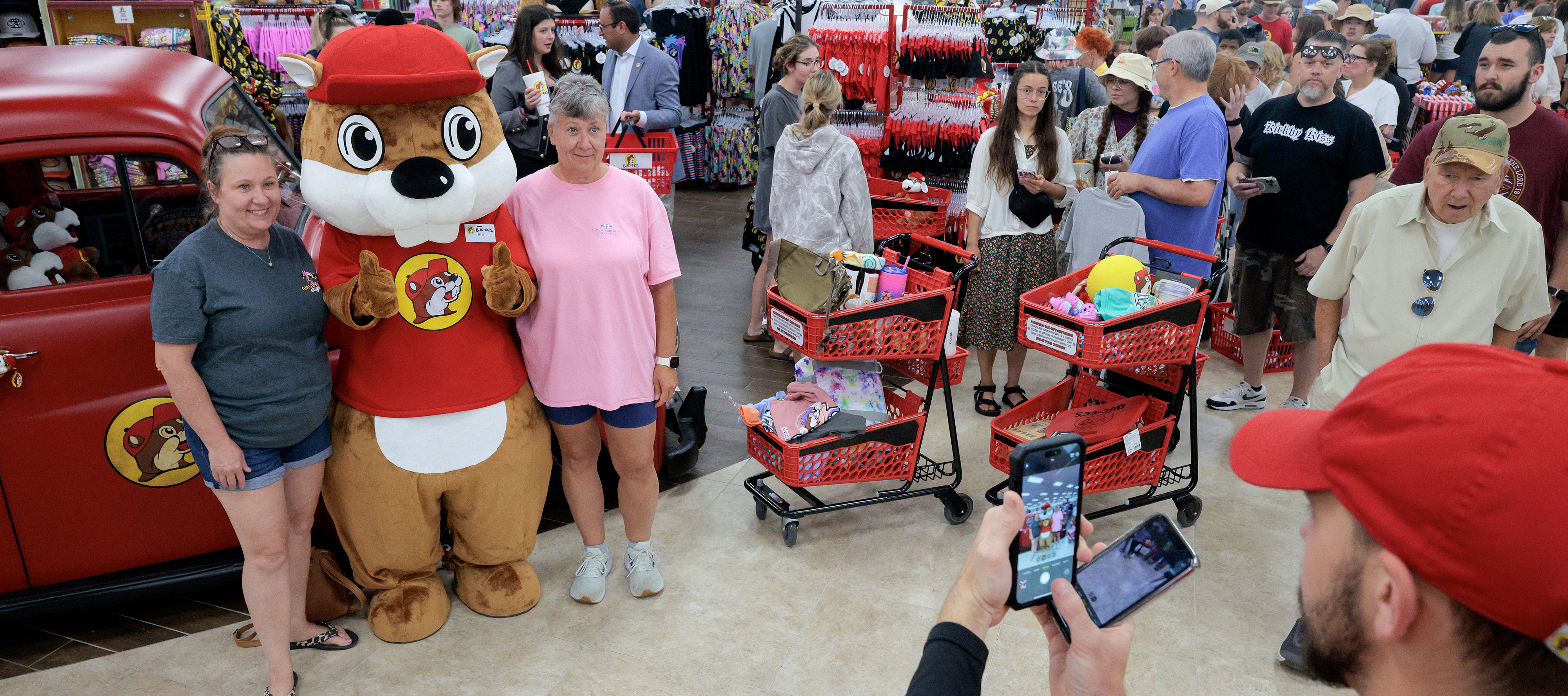 Cusomers stand in line to have their photograph taken with the Buc-ee's mascot during the grand opening of the first Buc-ee's location on the East Coast.