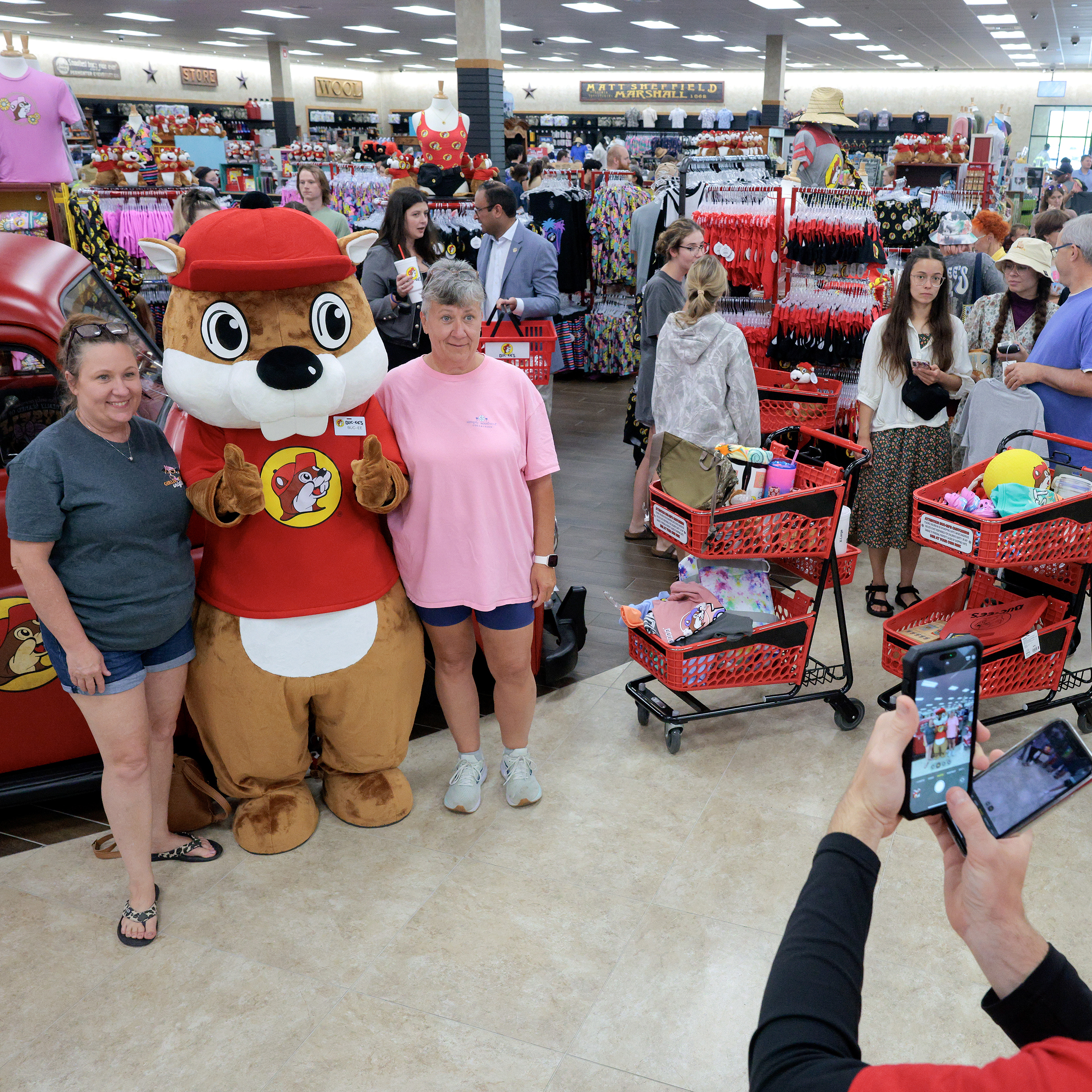 Cusomers stand in line to have their photograph taken with the Buc-ee's mascot during the grand opening of the first Buc-ee's location on the East Coast.