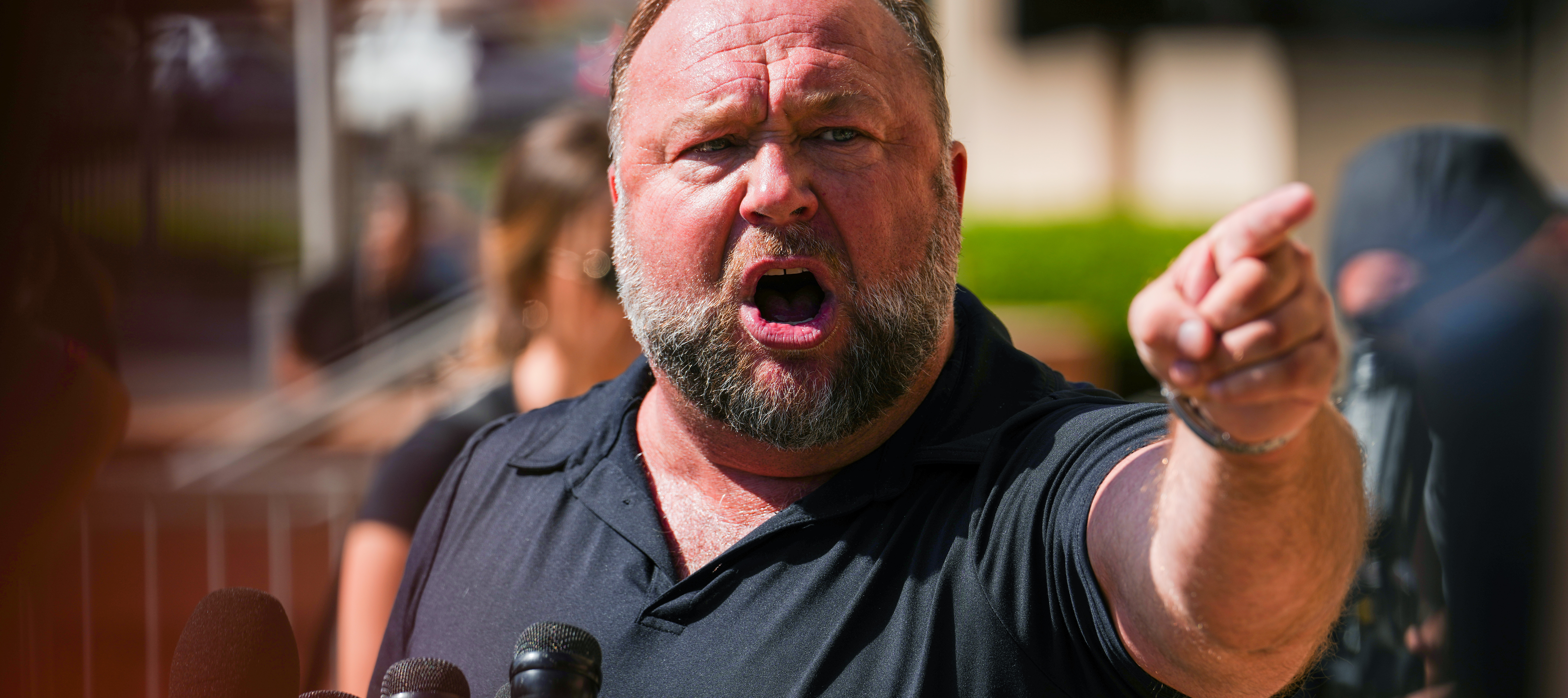 InfoWars founder Alex Jones speaks to the media outside Waterbury Superior Court on September 21, 2022.