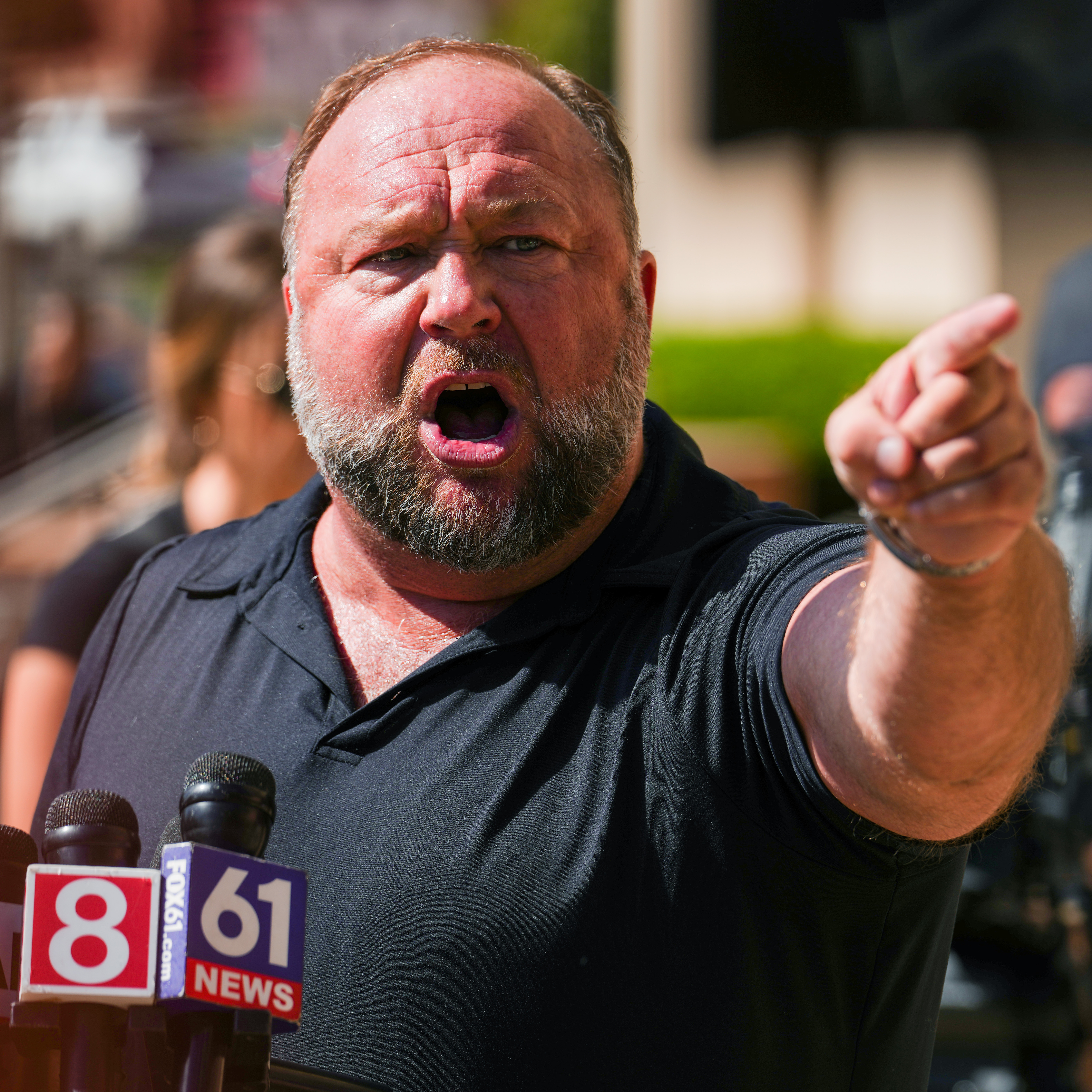 InfoWars founder Alex Jones speaks to the media outside Waterbury Superior Court on September 21, 2022.