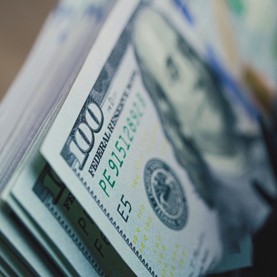 Cash counting machine counts hundred dollar bills.