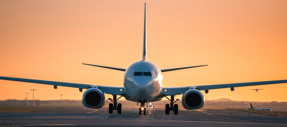 A photo of an airplane at sunset