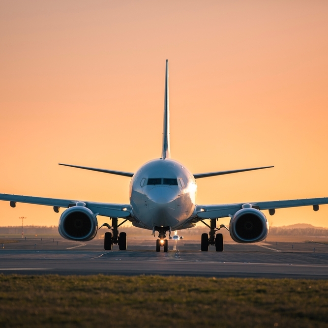 A photo of an airplane at sunset