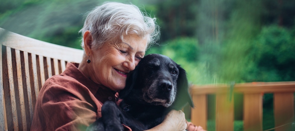 A photo of an older woman with a dog