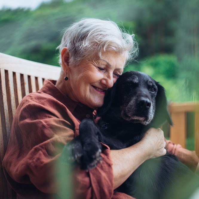 A photo of an older woman with a dog