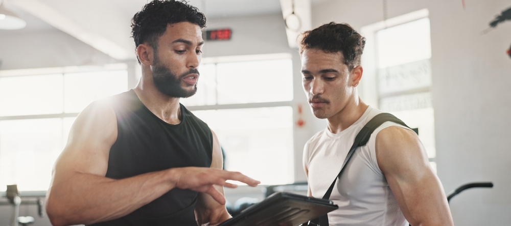 A photo of two men at the gym