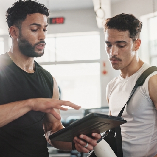 A photo of two men at the gym