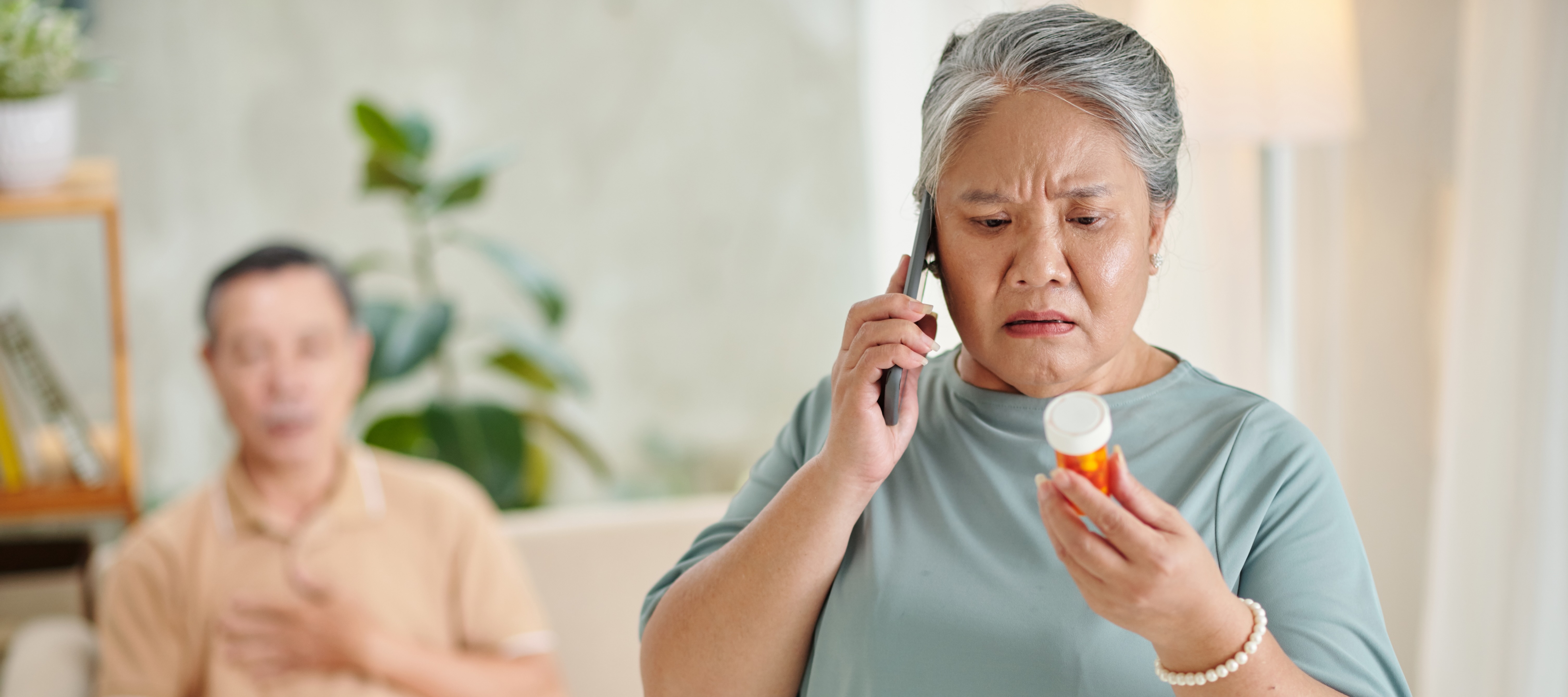 woman on phone with pill bottle