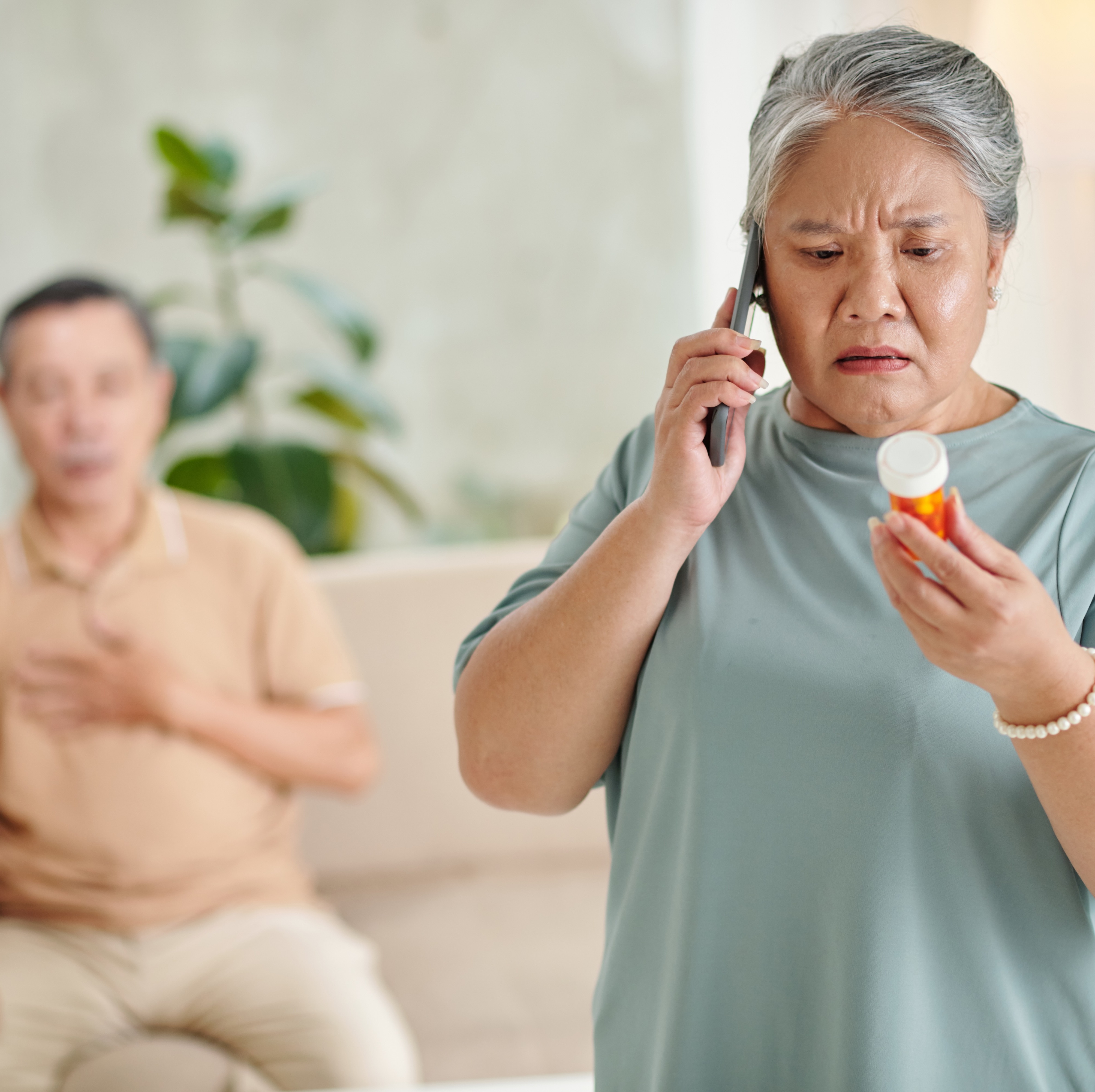 woman on phone with pill bottle