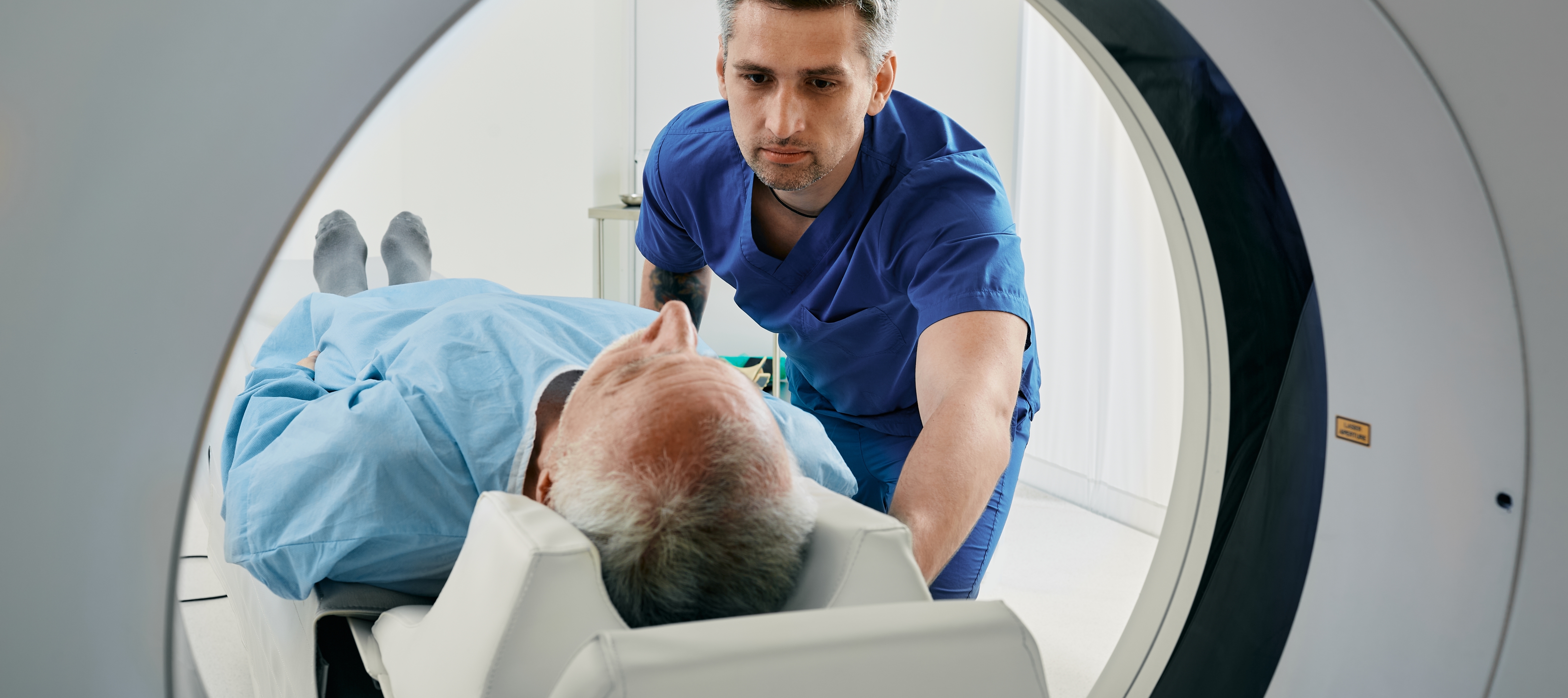 A nurse helps a patient with their MRI scan.