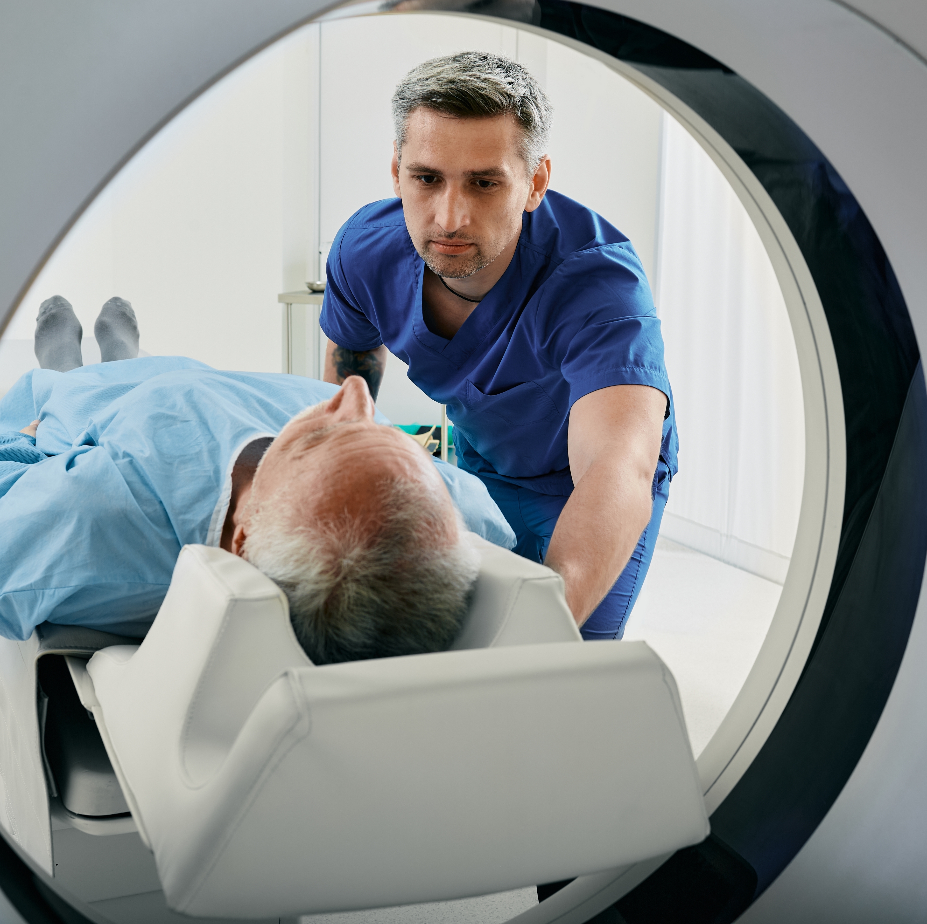 A nurse helps a patient with their MRI scan.