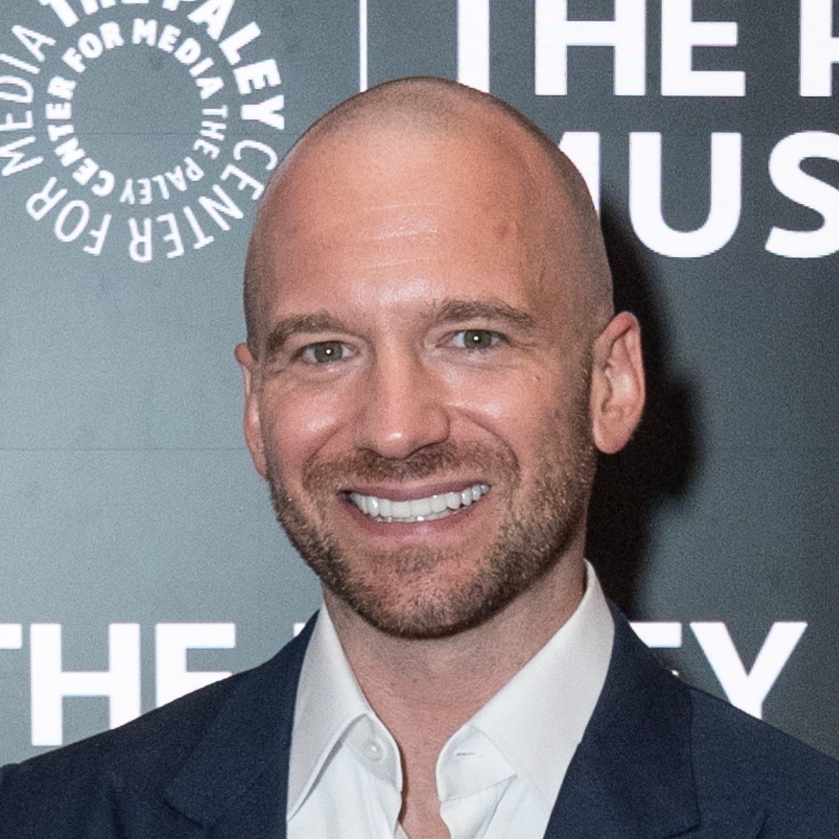 Sean Evans smiling at the camera on a red carpet