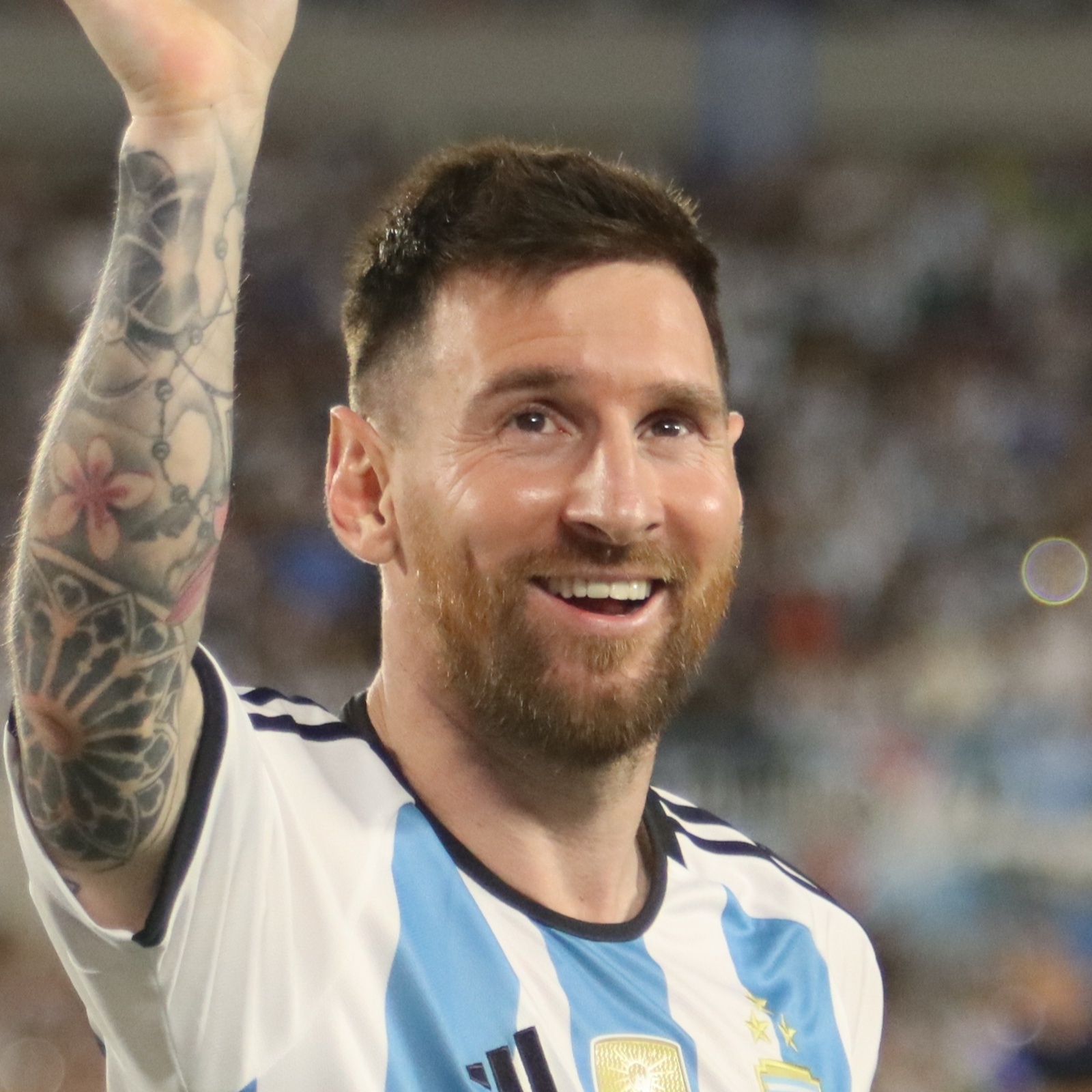 Argentina's Lionel Messi raises his hand and waves to the crowd