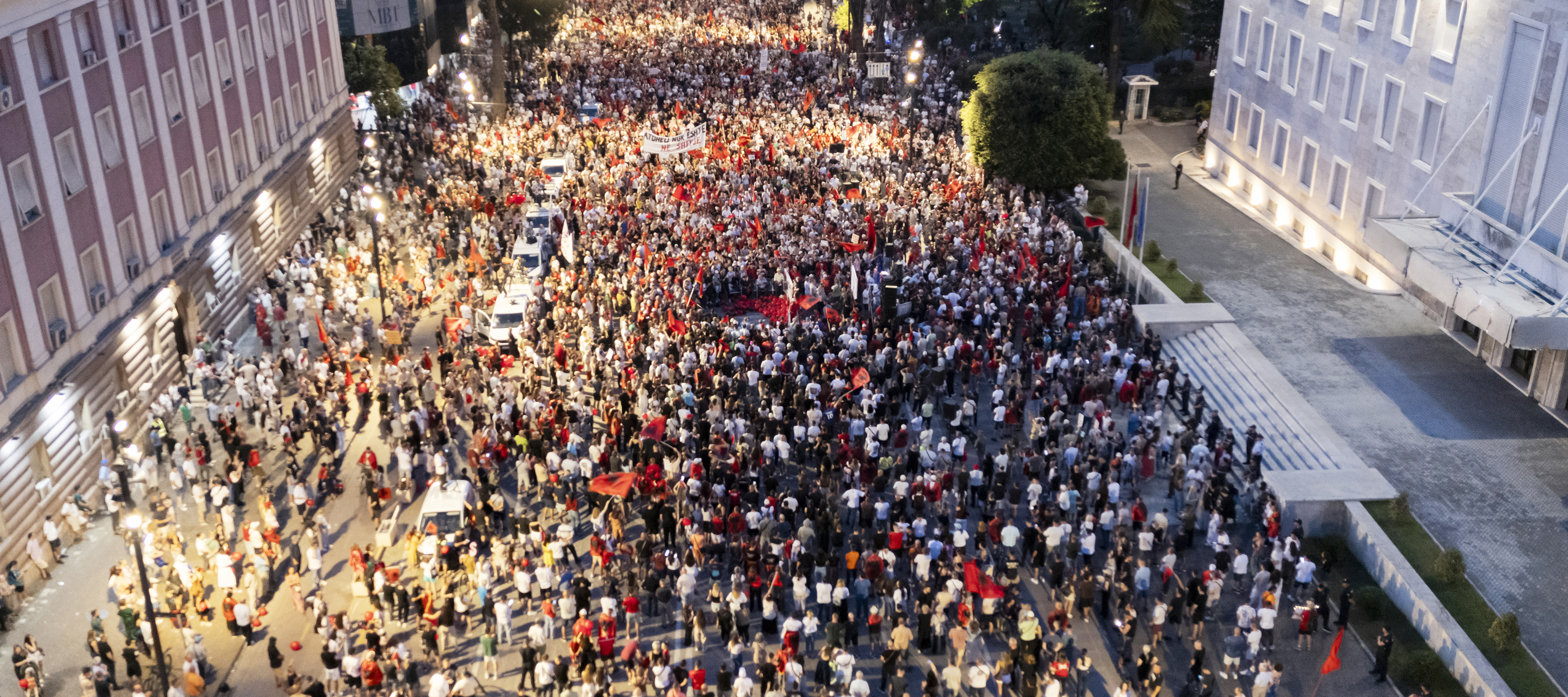 A drone view shows thousands of protesters carrying banners, placards, and Albanian flags in central Tirana, Albania, on June 21, 2026.
